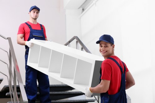 Movers preparing equipment and checking safety before a van loading task