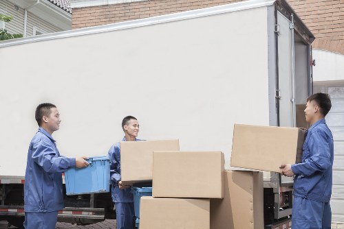 Removalists handling furniture on a residential street in Stockwell