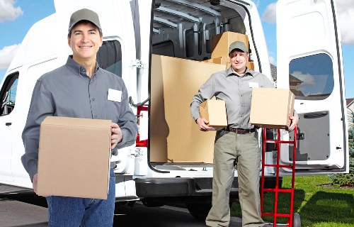 Local moving service loading boxes for urgent relocation in Stockwell